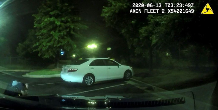 This undated handout photo obtained June 14, 2020, from the Atlanta (Georgia) Police Department shows an image from a video camera of a struggle a day earlier between police officers and suspect Rayshard Brooks (L)