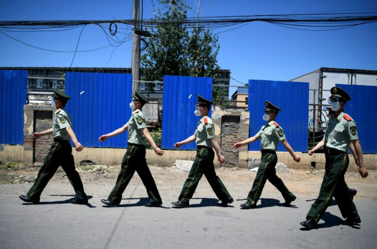 Paramilitary police have been deployed and nearby housing estates put into lockdown following the emergence of a new cluster of infections at a Beijing market