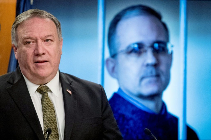 Secretary of State Mike Pompeo stands before an image of former US marine Paul Whelan as he urges his release during a news conference on June 10, 2020