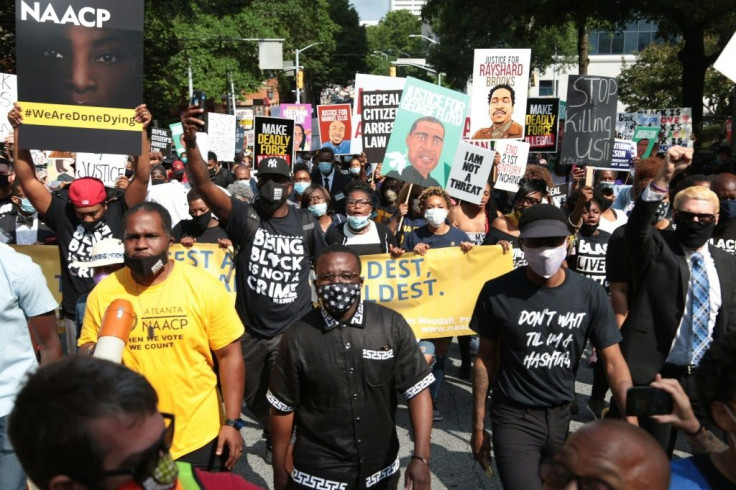 Protestors gather for a march organized by the National Association for the Advancement of Colored People (NAACP) in Atlanta, Georgia, to protest the fatal shooting of a black man by a white police officer