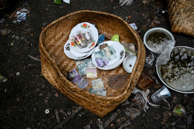 Relatives of the dead leave ceremonial offerings for use in the afterlife at the cemetery where Bali's Trunyanese people hold open-air burials