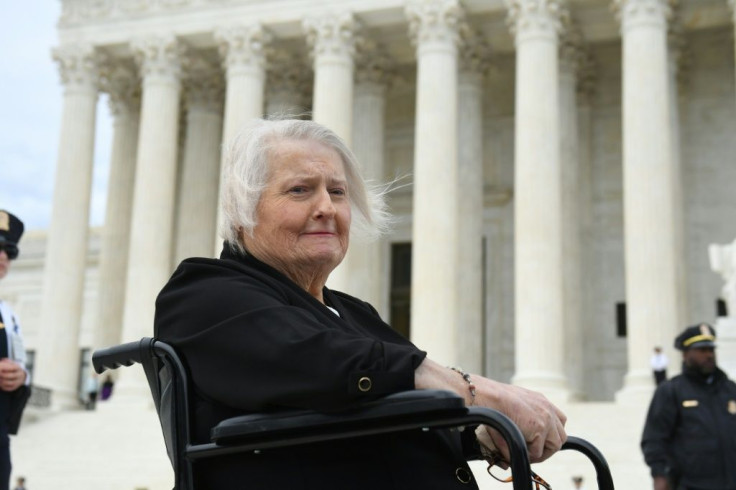 Transgender activist Aimee Stephens (pictured October 2019) sits in her wheelchair outside the US Supreme Court in Washington, which in June, 2020 ruled in favor of protecting LGBT rights in the workplace, a month after her death