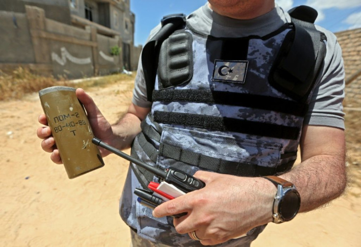 A Turkish deminer holds the remains of en explosive device in the Salah al-Din area. Human Rights Watch earlier this month accused pro-Haftar forces of laying Russian and Soviet-era landmines as they withdrew from Tripoli's southern districts