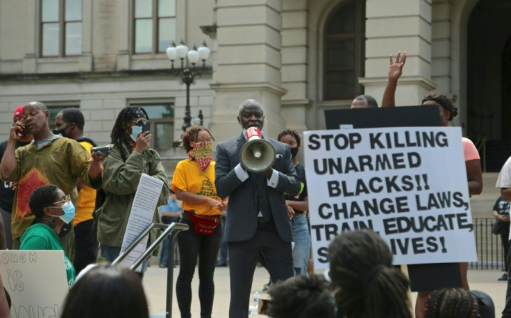 Protestors in Atlanta demonstrate on June 15 against the police shooting of 27-year-old Rayshard Brooks after Brooks was found asleep in his car at a fast food restaurant