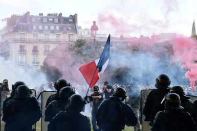 Tear gas hovers at the Les Invalides complex in central Paris during the protest
