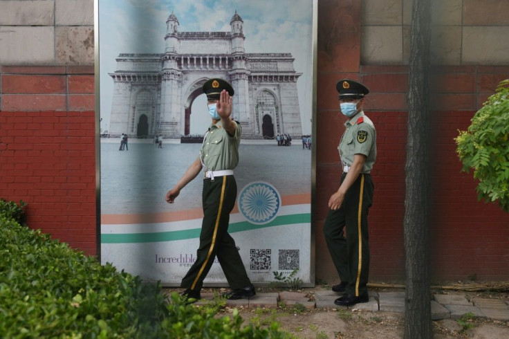 Two Chinese paramilitary police officers patrol outside the Indian embassy in Beijing on June 16, 2020.  Tensions have soared between the Asian giants after a deadly clash in the Himalayas, with the US and the UN calling for restraint