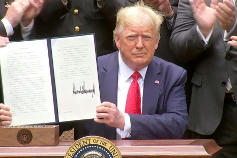 President Donald Trump signs an executive order on police reforms amid protests against police violence