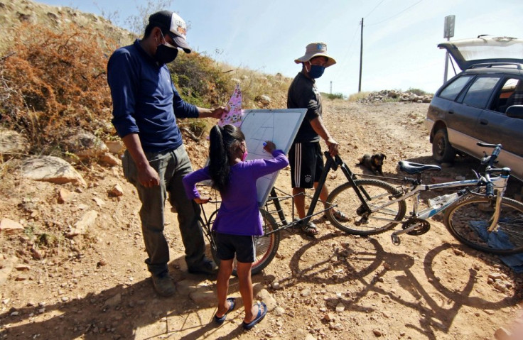 Negrete carries around his whiteboard to bring the school class to pupils' homes