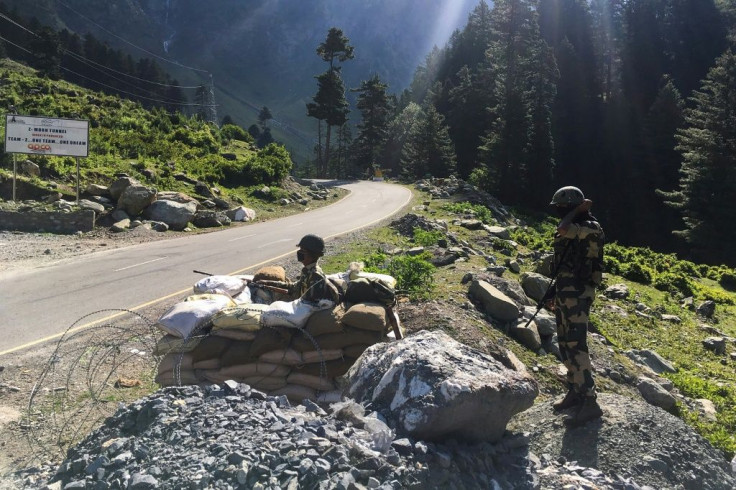 Indian Border Security Force (BSF) soldiers guard a highway leading towards Leh, bordering China, in Gagangir