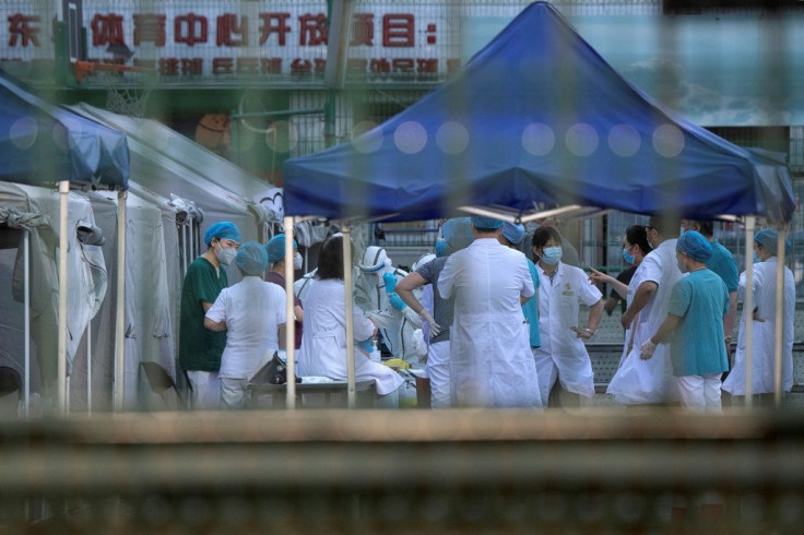 Medical workers gather at Beijing's Dongdan sports centre to conduct COVID-19 tests