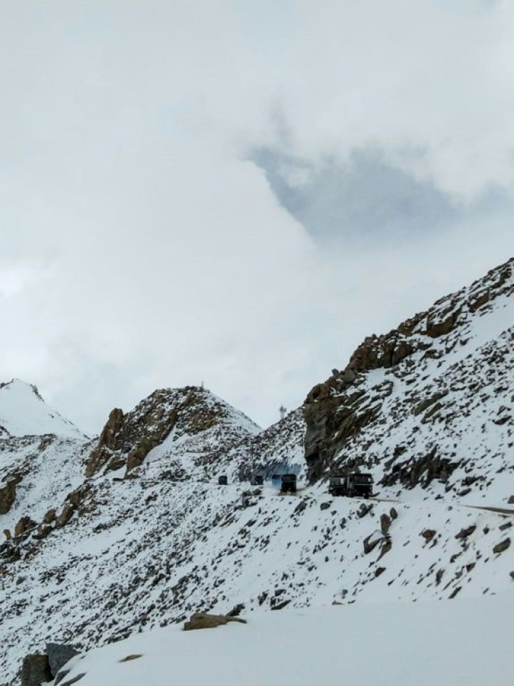 Indian Army vehicles drive on a road near the Chang La pass in northern India's Ladakh region, near the border with China