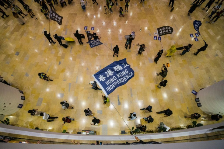 People shout slogans inside a shopping mall in Hong Kong, where protests have become a topic of friction between the United States and China