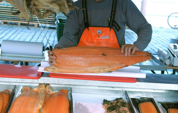 A fishmonger cuts salmon at the fish market near the Norwegian harbor of Bergen in September 2014