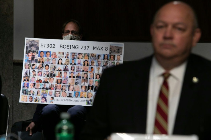 Michael Stumo holds a sign displaying photographs of the those killed in the March 10, 2019 crash of Ethiopian Airlines Flight 302 as Federal Aviation Administration (FAA) chief Steve Dickson testifies before a Senate panel