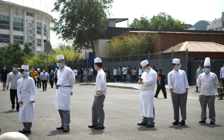 Restaurant workers line up in Beijing as part of a mass virus testing effort