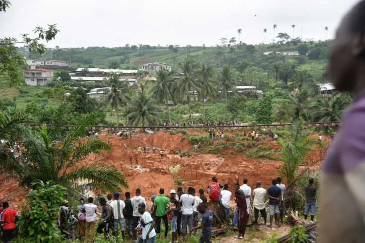 People look at the site of a landslide that killed at least 13 people in Anyama, a suburb of Abidjan.
