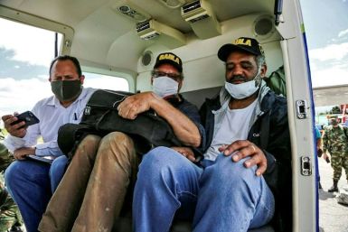 A handout photo from the Colombian National Army press office shows Swiss tourist Daniel Max Guggenheim (C) and Brazilian tourist Jose Ivan Albuquerque (R), who were kidnapped in March 2020 by alleged dissidents of the FARC guerrillas