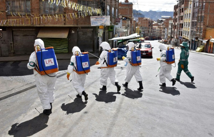 Municipal workers disinfect the streets of La Paz as a preventive measure to slow the spread of the novel coronavirus