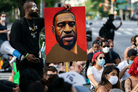 A man holds a picture of George Floyd during a Black Lives Matter protest in New York City