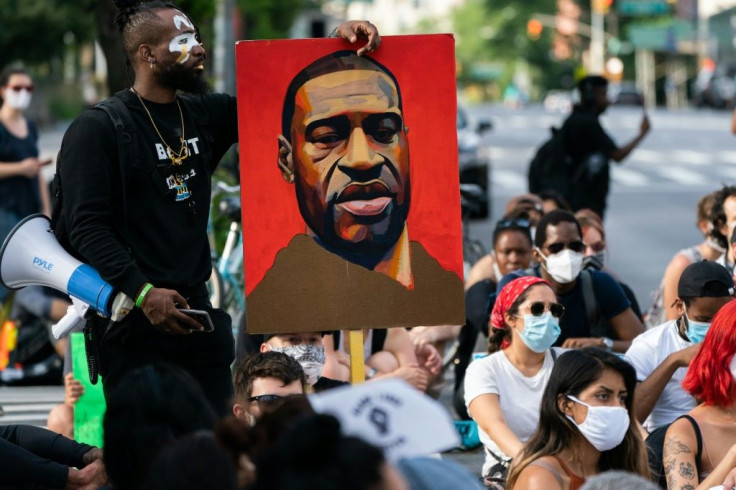 A man holds a picture of George Floyd during a Black Lives Matter protest in New York City
