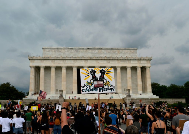 Demonstrators participate in a Juneteenth march and rally in front of the Lincoln Memorial in Washington