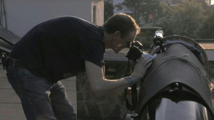 As a rare annular eclipse begins to sweep from Africa to Asia, an astronomer observes the sun from his backyard in the Kenyan capital Nairobi.