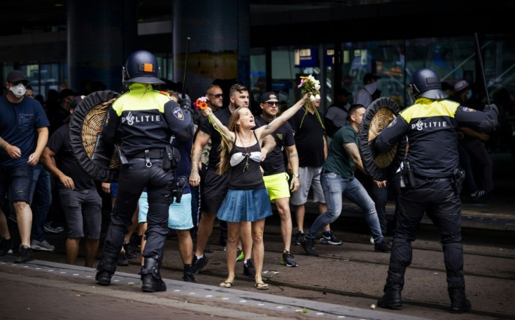 Hundreds of people gathered in the city centre, many carrying placards or holding hands, to demonstrate against measures including the 1.5 metre social distancing rule