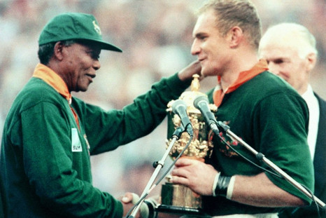 President Nelson Mandela (L) hands the Rugby World Cup trophy to South Africa captain Francois Pienaar after the 1995 final in Johannesburg