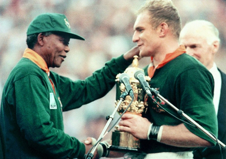 President Nelson Mandela (L) hands the Rugby World Cup trophy to South Africa captain Francois Pienaar after the 1995 final in Johannesburg