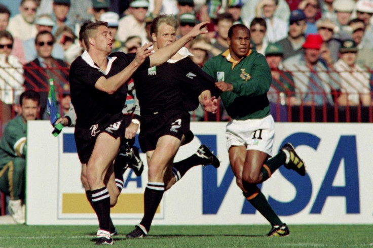 All Blacks Glen Osborne (L) and Jeff Wilson and Springbok Chester Williams seek possession during the 1995 Rugby World Cup final in Johannesburg
