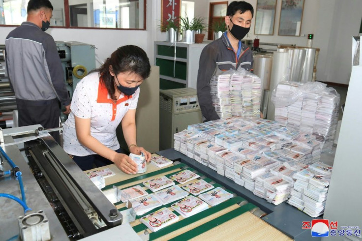 North Koreans prepare anti-Seoul leaflets at an undisclosed North Korean location, in an undated picture released by North Korea's official Korean Central News Agency (KCNA) on June 20, 2020