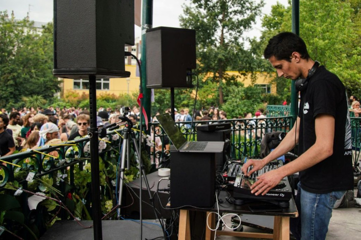 A DJ plays as revellers pack the Paris streets in Sunday's annual music festival in France