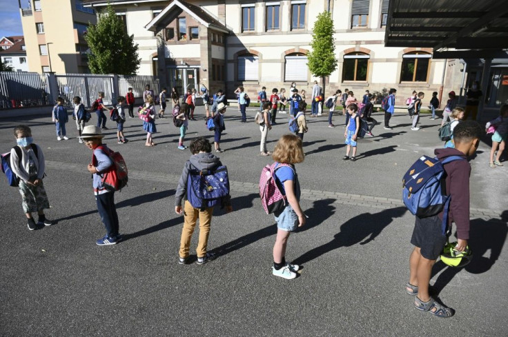 Children queue to enter their classrooms in Strasbourg as schools opened up across France