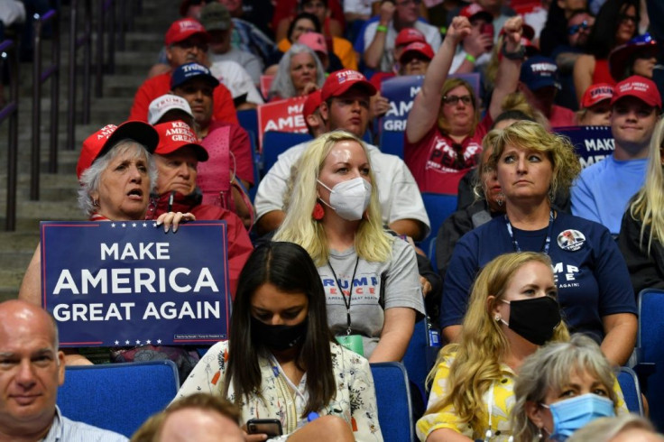 Supporters of US President Donald Trump listen to him speak at his Tulsa campaign rally