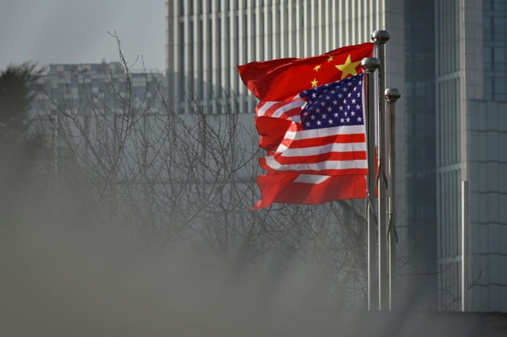 Chinese and US national flags flutter at the entrance of an office in Beijing in January 2020
