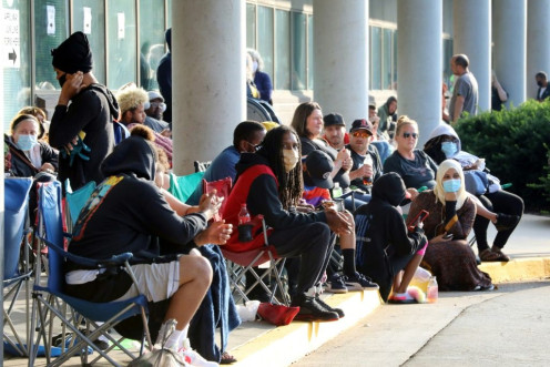 Hundreds of unemployed people wait outside the Kentucky Career Center in Frankfort, Kentucky for help with their unemployment claims