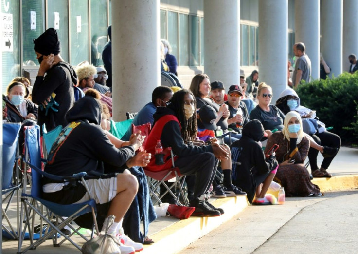 Hundreds of unemployed people wait outside the Kentucky Career Center in Frankfort, Kentucky for help with their unemployment claims