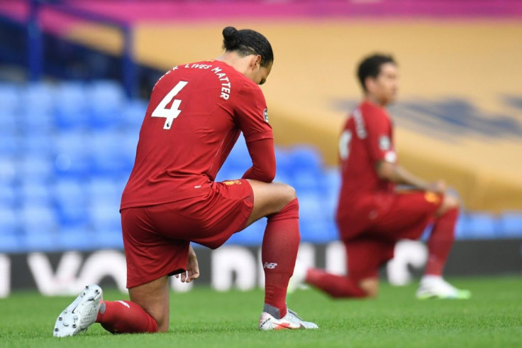 Liverpool's Virgil van Dijk (left) takes a knee as all Premier League players showed their support for the Black Lives Matter campaign