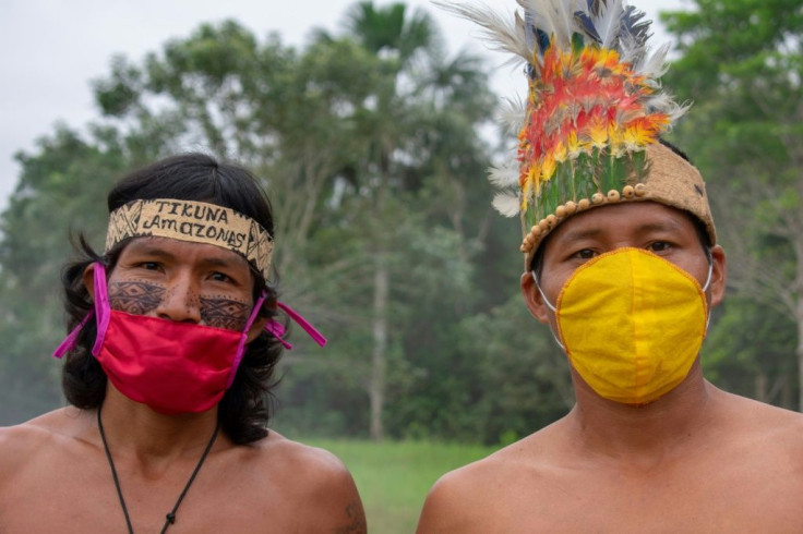 Members of the Ticuna community in El Progresso, Colombia pose with face masks