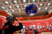 A boy looks at a model of the BeiDou Navigation Satellite System at the National Museum of China in Beijing