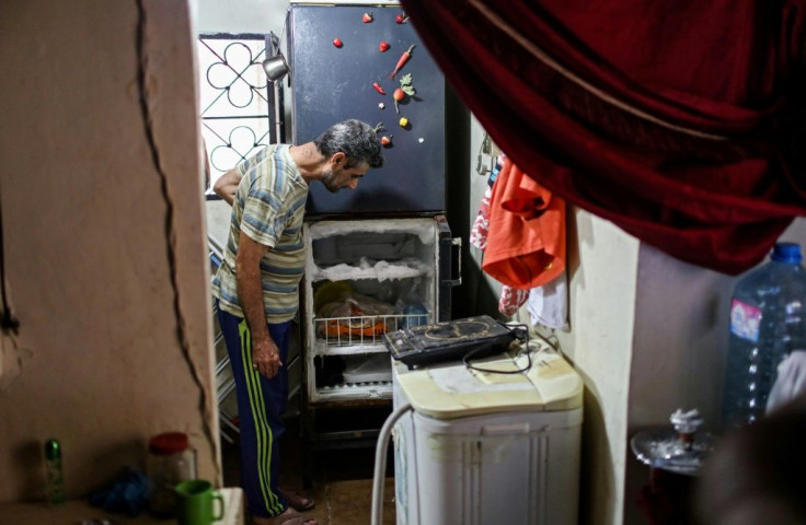 A Lebanese man looks at his empty refrigerator at his apartment in the capital Beirut on June 17, 2020