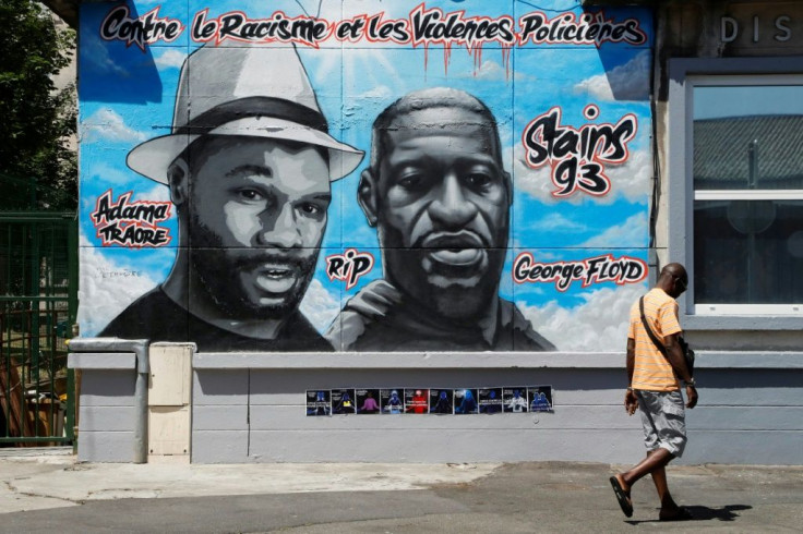 A mural of Adama Traore, left, and George Floyd with the heading "Against racism and police violence" in Stains, a city outside Paris.
