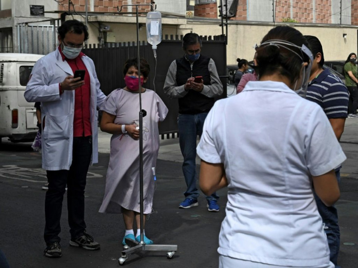 People gather outside a hospital in Mexico City, on June 23, 2020, after a powerful quake rocked the south of the county