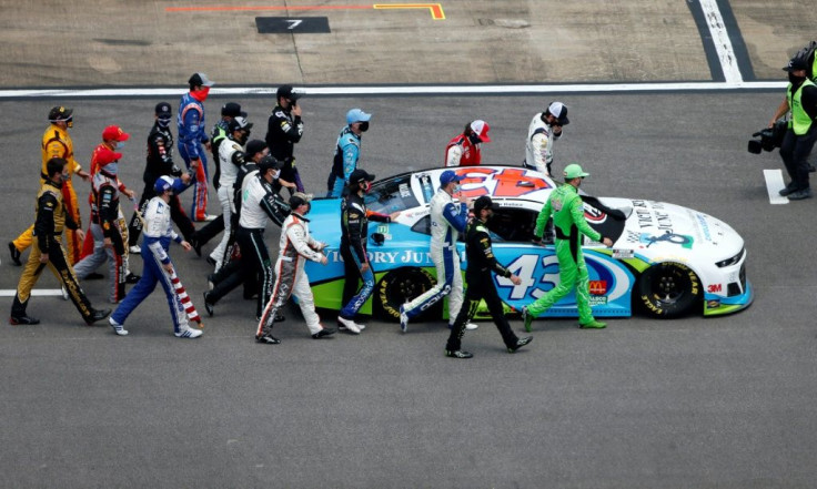 NASCAR drivers push the #43 Victory Junction Chevrolet, driven by Bubba Wallace, to the front of the grid as a sign of solidarity with the African American driver prior to the NASCAR Cup Series race Talladega, Alabama