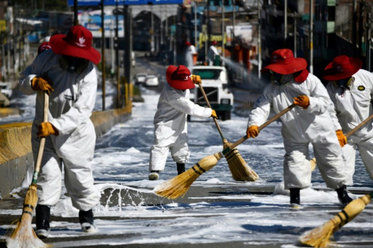 Municipal workers in Arequipa, the second largest city in Peru, clean roads around the main market