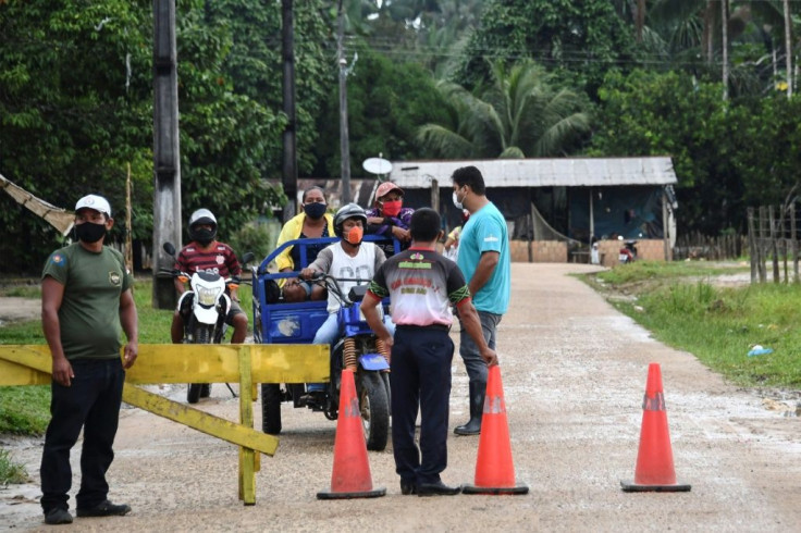 Indigenous civil guards of the Ticuna ethnic group remain at the entrance of the Umariacu village, in Tabatinga, Amazonas state, Brazil, amid the new coronavirus pandemic