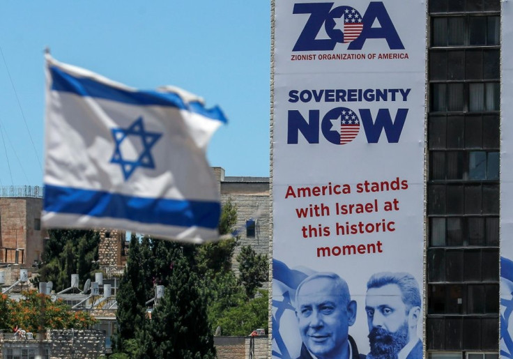 A banner in Jerusalem of the Zionist Organisation Of America, next to an Israeli flag, pledges support for Israel's plan to annex parts of the occupied West Bank