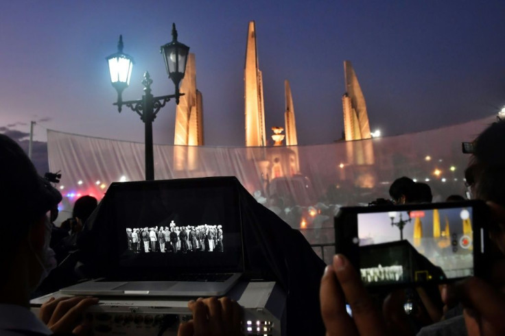 Pro-democracy activists projected footage of the 1932 declaration of the end of absolute monarchy onto a monument in Bangkok