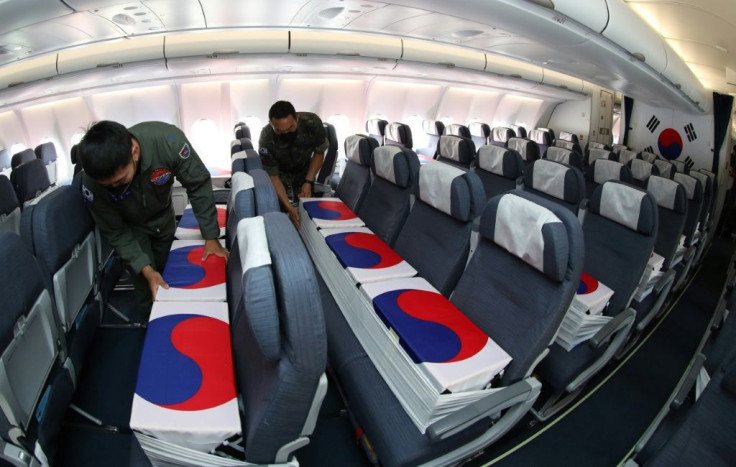 Flag-wrapped coffins containing the remains of nearly 150 South Koreans killed in the Korean War were flown back to Seoul