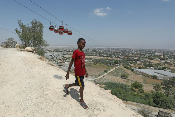 A Palestinian youth walks down a hillside overlooking Jericho in the West Bank, where Israel is controversially considering annexation